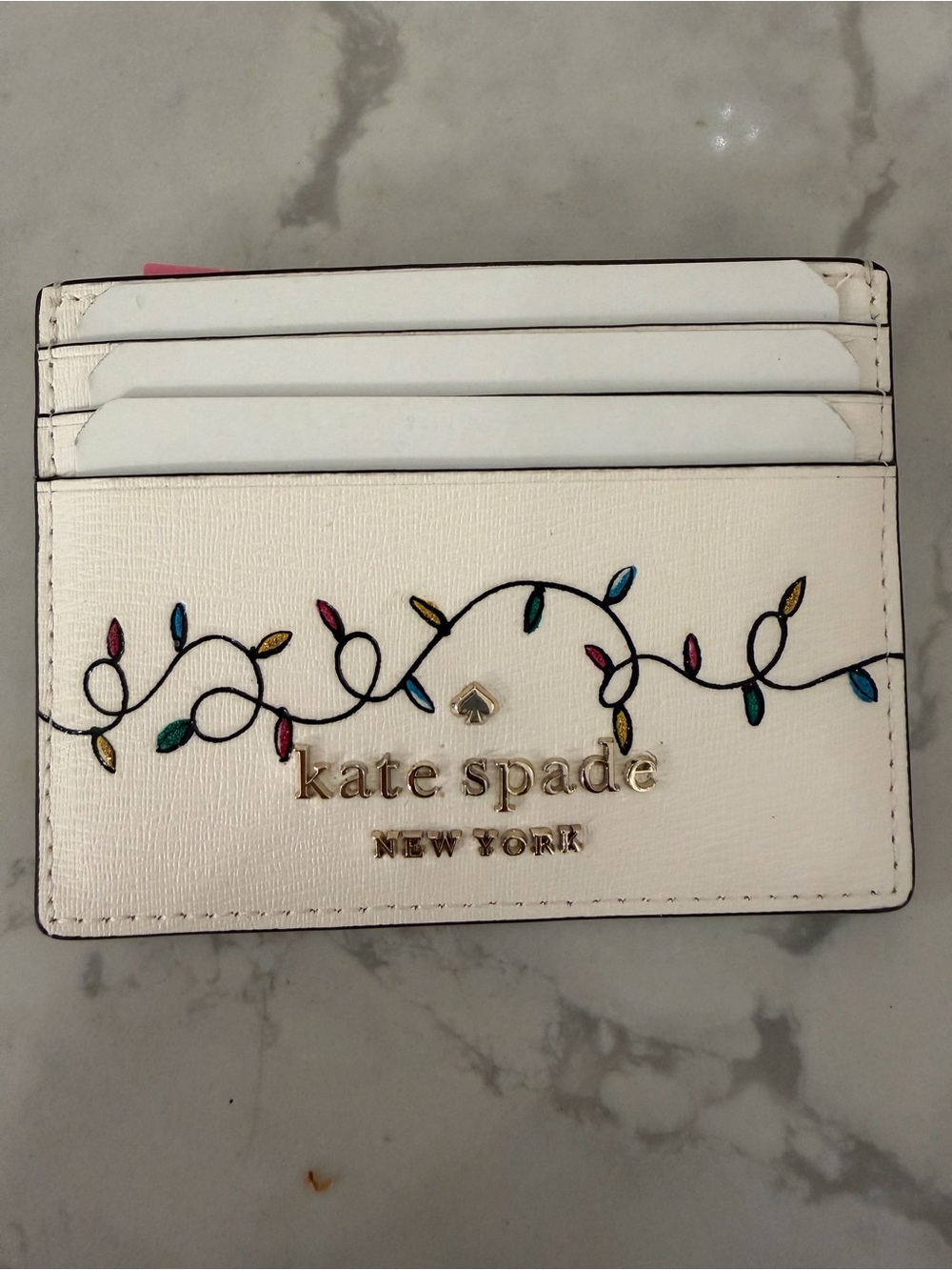 kate spade white leather cardholder with colorful Christmas light-strand
